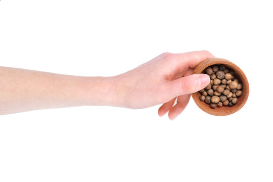 Hand Holding Wooden Bowl With Aromatic Allspice Isolated On White