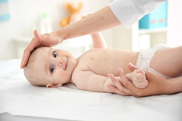Doctor doing exercises with baby