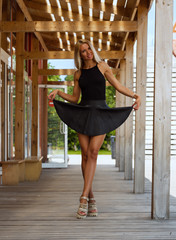 Beautiful girl in a short black skirt
