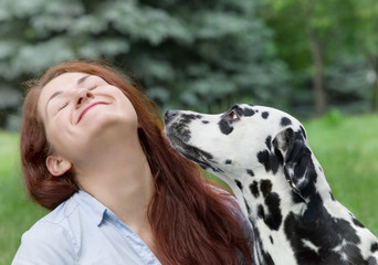 Dog is going to kiss his owner -- young woman