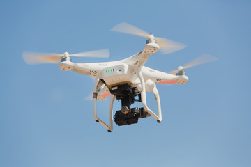 Drone flying with clear blue sky