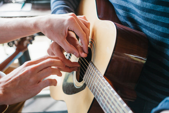 Learning to play the guitar. Music education and extra-curricular lessons.