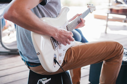 Man playing electric guitar. Subculture.