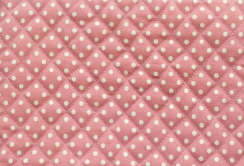 white Polka dot over pink fabric table texture background