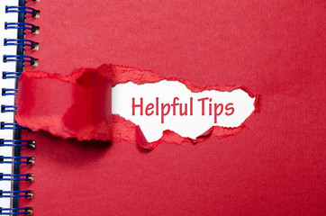 The word helpful tips appearing behind torn paper - 114347937