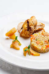 Fried chicken, served with pearl barley and vegetables