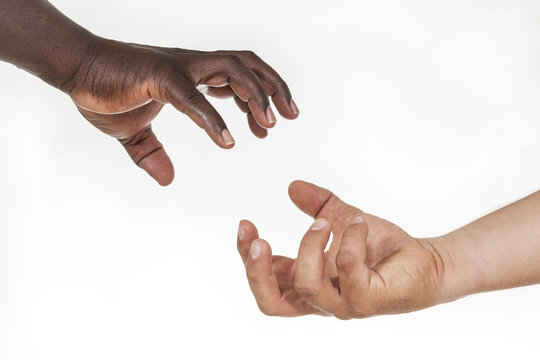 Interracial helping hands: humanity and brotherhood concept. White background