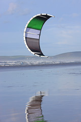 Power kite reflected on a beach