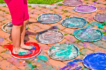 feet of children full of colorful gouache