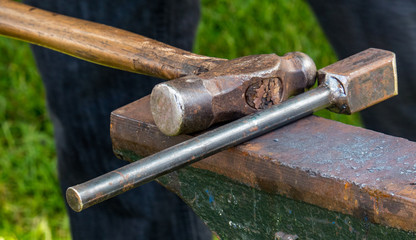 Detailed shot of metal being worked at a blacksmithing forge