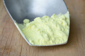 sulfur powder on iron scoop