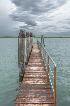 Wooden old pier at Burano, an island nearby Venice, Italy © neurobite