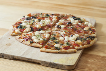 Delicious homemade pizza with tomato, cheese, pepperoni, olives and mushrooms.