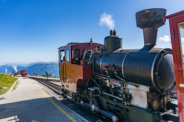 Fototapeta na wymiar The steam train takes tourists to Schafberg mountain peak in the