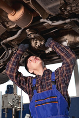 Fototapeta na wymiar Car mechanic working in auto repair service