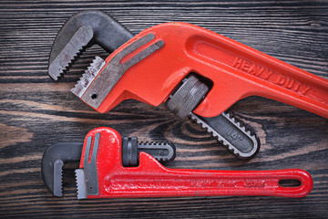 Pipe wrenches on wooden board horizontal view plumbing concept