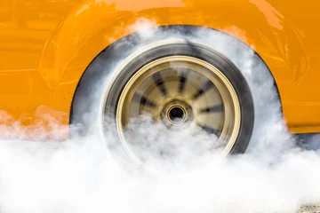 Poster Drag racing car burns rubber off its tire in preparation for the race © toa555