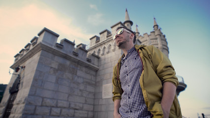 Fototapeta premium a man wearing glasses and a jacket inspects recreation.