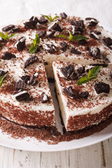 Sweet cheese cake with chunks of chocolate cookies close-up. Vertical
