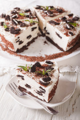 Delicious cheesecake with chocolate cookies closeup. vertical

