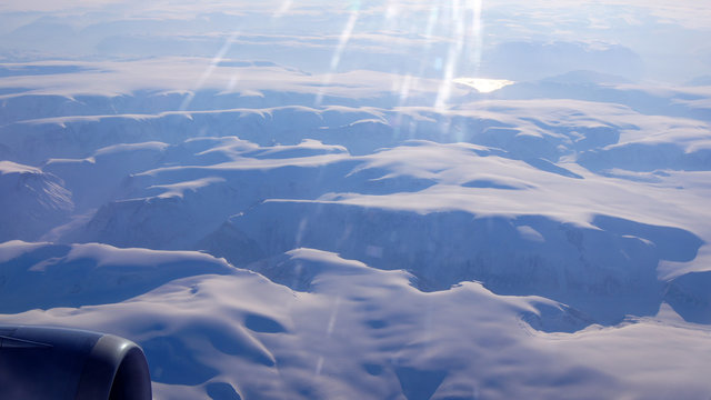 Greenland as seen from the sky, wing view with airplane turbine
