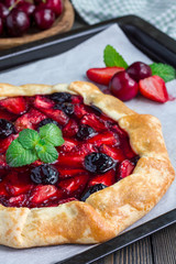 Cottage cheese dough galette with strawberry and cherry, vertical