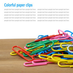 Paper clips on table isolated on white background