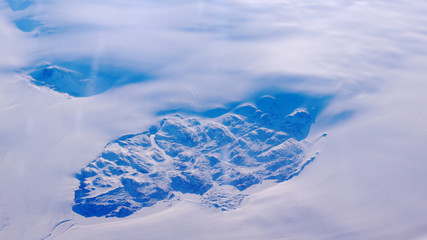 Greenland as seen from the sky, wing view with airplane turbine