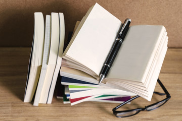 Stack of books on wooden table