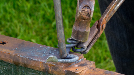 Detailed shot of metal being worked at a blacksmithing forge