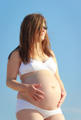 Pregnant woman holding belly,Beautiful pregnant woman in underwear,natural sunlight on the skin