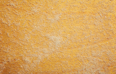 The sugar scattered on a wooden surface