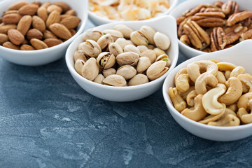 Variety of nuts in small bowls