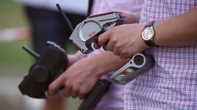 The man using the remote control controls radio-controlled drift car
