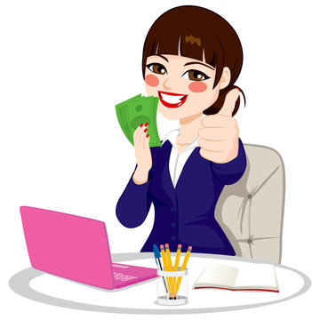 Successful businesswoman with green banknote money fan making thumbs up gesture sitting on office desk with laptop