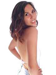 Obraz premium young woman in white bathing suit and denim shorts looking up 