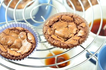 freshly baked chocolate muffins cooling off on wire mesh