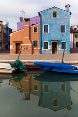 Fototapeta na wymiar Venetian island of Burano is known for its brightly colored homes. The colors of the houses follow a specific system originating in the middle ages.
