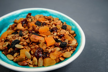 Muesli in plate over gray background. Close up.