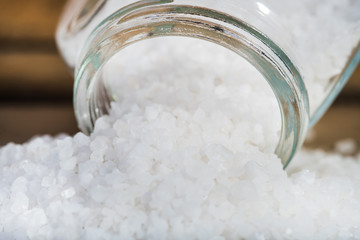 Sea salt on a wooden background.
