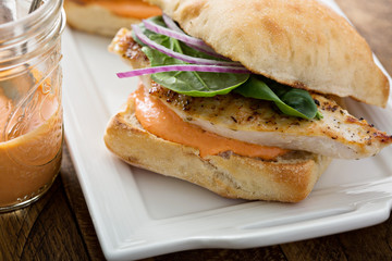 Grilled chicken sandwich with red pepper sauce
