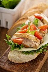 Grilled chicken sandwich with basil and tomatoes