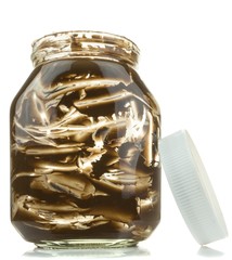 An empty glass jar of chocolate spread on a white background