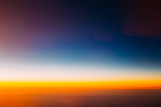 Scenic View Of Sunset From Height Of Airplane. Dark Sunrise Sky.