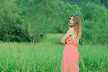 Fototapeta na wymiar beautiful young woman on field at sunset