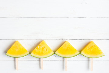 popsicle yellow watermelon on wooden white background, top view, flat lay