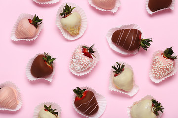 Strawberries covered in chocolate on a pink background - Powered by Adobe