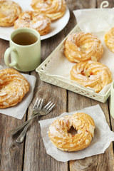 Sweet eclairs on a grey wooden table