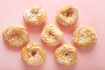 Sweet and tasty eclairs on a pink background