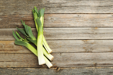 Green leeks on a grey wooden table